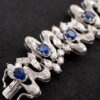 Sapphire Diamond Bracelet White Gold White gold bracelet with oval blue sapphires and diamond-set articulated links in a sculptural design