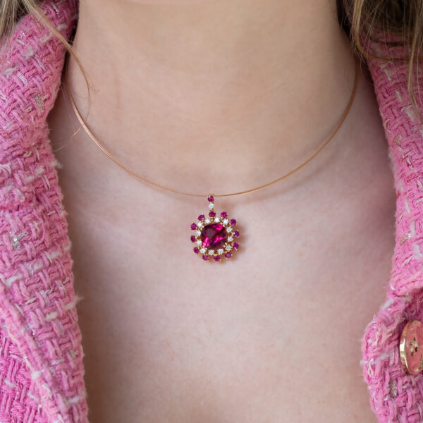 Floral Rubellite, Ruby & Diamond Cluster Pendant Necklace in Rose Gold Close-up of a 18K rose gold pendant necklace featuring a central rubellite surrounded by rubies and diamonds in a floral cluster design