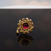 Floral Rubellite, Ruby & Diamond Cluster Pendant Necklace in Rose Gold Close-up of a 18K rose gold pendant necklace featuring a central rubellite surrounded by rubies and diamonds in a floral cluster design