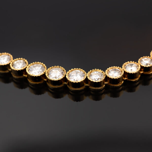 Milgrain Diamond Tennis Necklace Yellow Gold 18k yellow gold tennis necklace with graduated round diamonds in a milgrain setting.