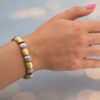Italian Dual-Tone Gold Sculptural Bracelet Italian 18K white and yellow gold sculptural bracelet with textured engraved links, rounded connectors, and heart motifs on reverse.