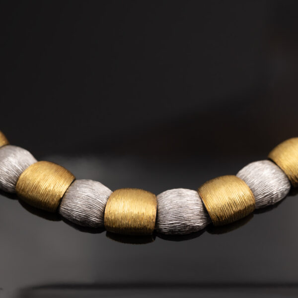 Italian Dual-Tone Gold Sculptural Necklace Italian 18K white and yellow gold sculptural necklace with textured engraved links and rounded connectors.