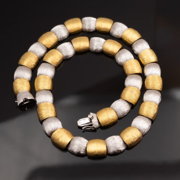 Italian Dual-Tone Gold Sculptural Necklace Italian 18K white and yellow gold sculptural necklace with textured engraved links and rounded connectors.