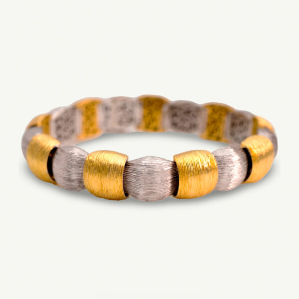 Italian Dual-Tone Gold Sculptural Bracelet Italian 18K white and yellow gold sculptural bracelet with textured engraved links, rounded connectors, and heart motifs on reverse.