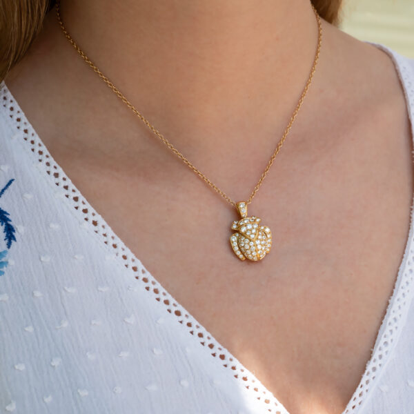 Diamond Scarab Pendant in 18K Yellow Gold Sculptural 18K yellow gold scarab pendant set with diamonds, featuring a domed beetle design with geometric detailing and high-jewelry finish.
