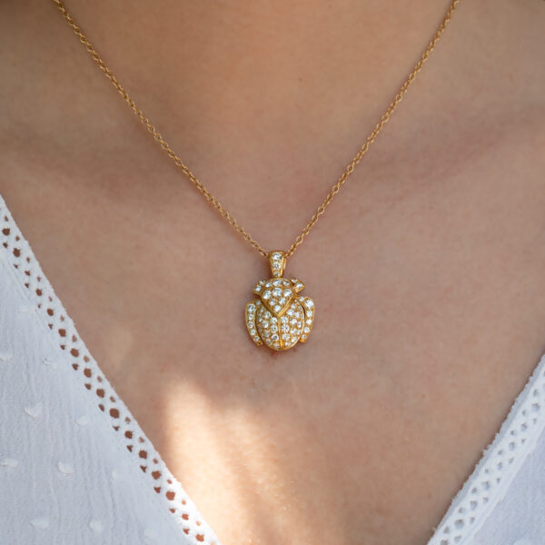 Diamond Scarab Pendant in 18K Yellow Gold Sculptural 18K yellow gold scarab pendant set with diamonds, featuring a domed beetle design with geometric detailing and high-jewelry finish.