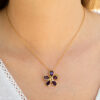 Amethyst Flower Pendant in 18K Yellow Gold 18K yellow gold flower pendant set with five pear-cut amethysts surrounding a diamond-set centre.