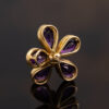Amethyst Flower Pendant in 18K Yellow Gold 18K yellow gold flower pendant set with five pear-cut amethysts surrounding a diamond-set centre.