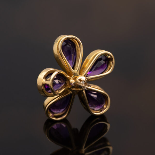 18K yellow gold flower pendant set with five pear-cut amethysts surrounding a diamond-set centre.