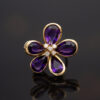 Amethyst Flower Ring in 18K Yellow Gold 18K yellow gold flower ring set with five pear-cut amethysts surrounding a diamond-set centre.