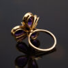 Amethyst Flower Ring in 18K Yellow Gold 18K yellow gold flower ring set with five pear-cut amethysts surrounding a diamond-set centre.
