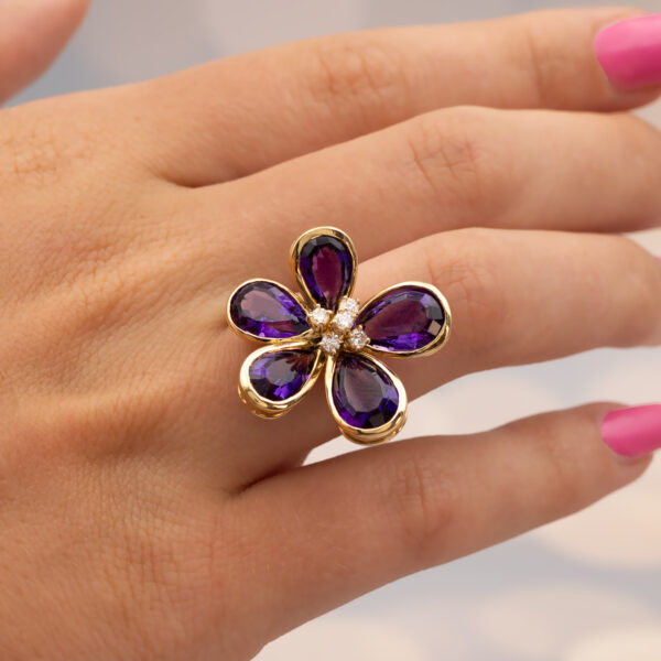 18K yellow gold flower ring set with five pear-cut amethysts surrounding a diamond-set centre.