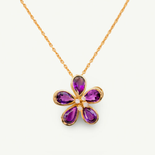 Amethyst Flower Pendant in 18K Yellow Gold 18K yellow gold flower pendant set with five pear-cut amethysts surrounding a diamond-set centre.