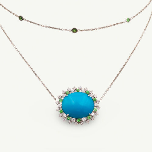 Turquoise Tsavorite Diamond Sunburst Necklace in White Gold White gold pendant necklace with oval turquoise centre surrounded by tsavorites and diamonds in a floral sunburst motif.