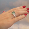 Green Tourmaline Blossom Ring in 18K White Gold 18K white gold ring with a cushion-shaped green tourmaline surrounded by pear-shaped and brilliant-cut diamonds in a floral-inspired setting.