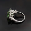 Green Tourmaline Blossom Ring in 18K White Gold 18K white gold ring with a cushion-shaped green tourmaline surrounded by pear-shaped and brilliant-cut diamonds in a floral-inspired setting.