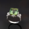 Green Tourmaline Blossom Ring in 18K White Gold 18K white gold ring with a cushion-shaped green tourmaline surrounded by pear-shaped and brilliant-cut diamonds in a floral-inspired setting.