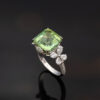 Green Tourmaline Blossom Ring in 18K White Gold 18K white gold ring with a cushion-shaped green tourmaline surrounded by pear-shaped and brilliant-cut diamonds in a floral-inspired setting.