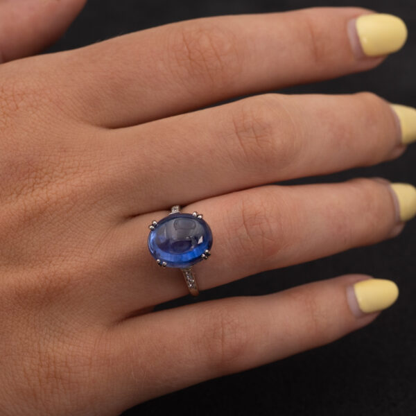 Natural Unheated Ceylon Sapphire Cabochon Ring in 18K White Gold Natural unheated Sri Lankan Ceylon blue sapphire cabochon ring in 18K white gold with diamond-set shoulders.