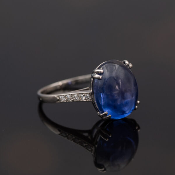 Natural Unheated Ceylon Sapphire Cabochon Ring in 18K White Gold Natural unheated Sri Lankan Ceylon blue sapphire cabochon ring in 18K white gold with diamond-set shoulders.