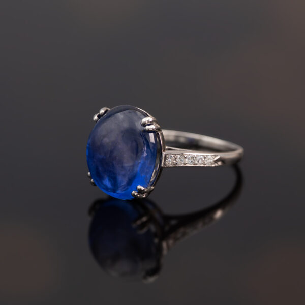 Natural Unheated Ceylon Sapphire Cabochon Ring in 18K White Gold Natural unheated Sri Lankan Ceylon blue sapphire cabochon ring in 18K white gold with diamond-set shoulders.