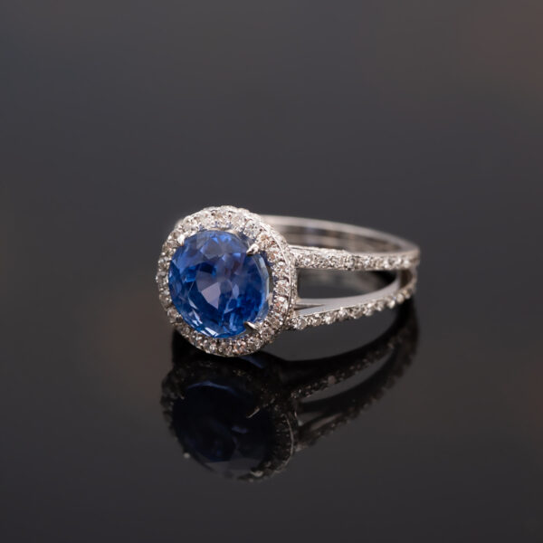Natural Unheated Ceylon Cornflower Blue Sapphire Halo Ring in 18K White Gold Certified natural unheated cornflower blue Ceylon sapphire halo ring with diamonds in 18K white gold.
