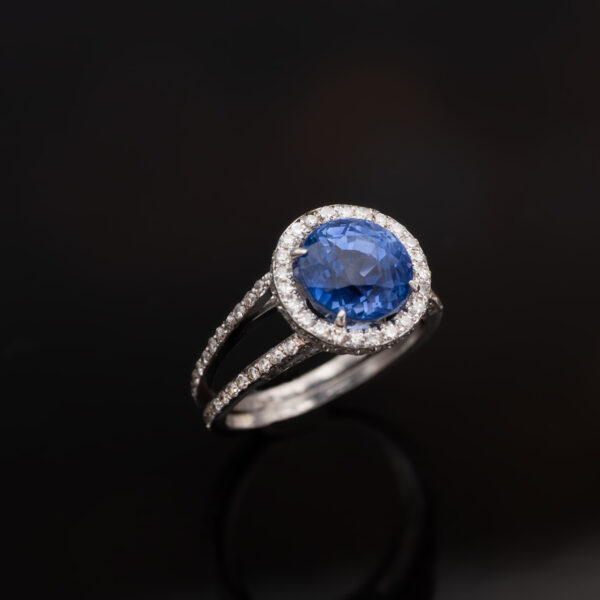 Natural Unheated Ceylon Cornflower Blue Sapphire Halo Ring in 18K White Gold Certified natural unheated cornflower blue Ceylon sapphire halo ring with diamonds in 18K white gold.