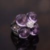 Amethyst Flower Ring in 18K White Gold 18K white gold flower ring with four amethyst cabochons and a diamond centre.