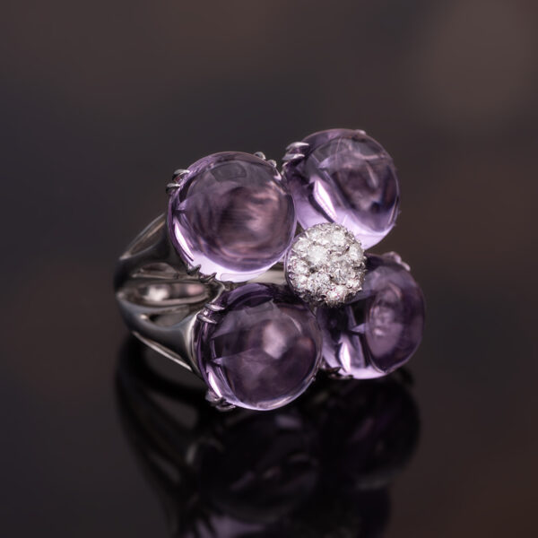 Amethyst Flower Ring in 18K White Gold 18K white gold flower ring with four amethyst cabochons and a diamond centre.