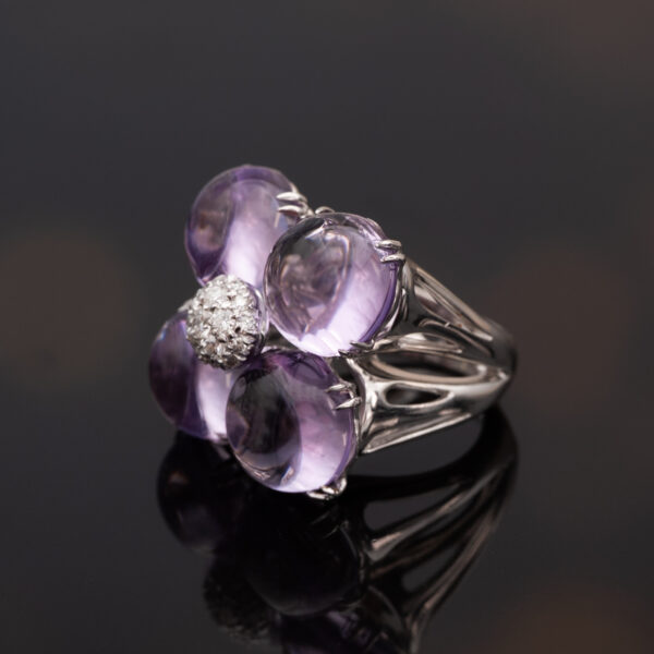 Amethyst Flower Ring in 18K White Gold 18K white gold flower ring with four amethyst cabochons and a diamond centre.