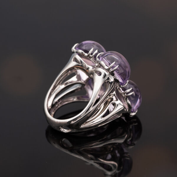 Amethyst Flower Ring in 18K White Gold 18K white gold flower ring with four amethyst cabochons and a diamond centre.