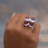 Amethyst Flower Ring in 18K White Gold 18K white gold flower ring with four amethyst cabochons and a diamond centre.